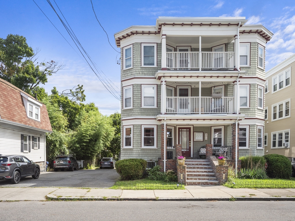 a front view of a residential apartment building with a yard