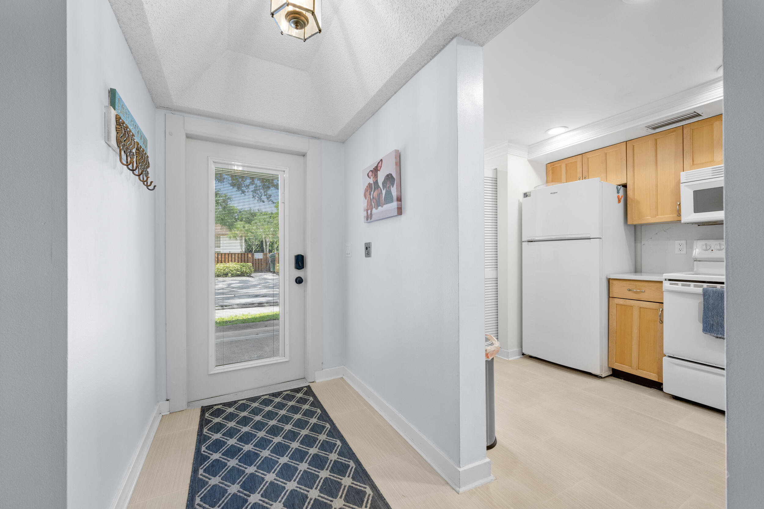 a view of a hallway to a bedroom with a window