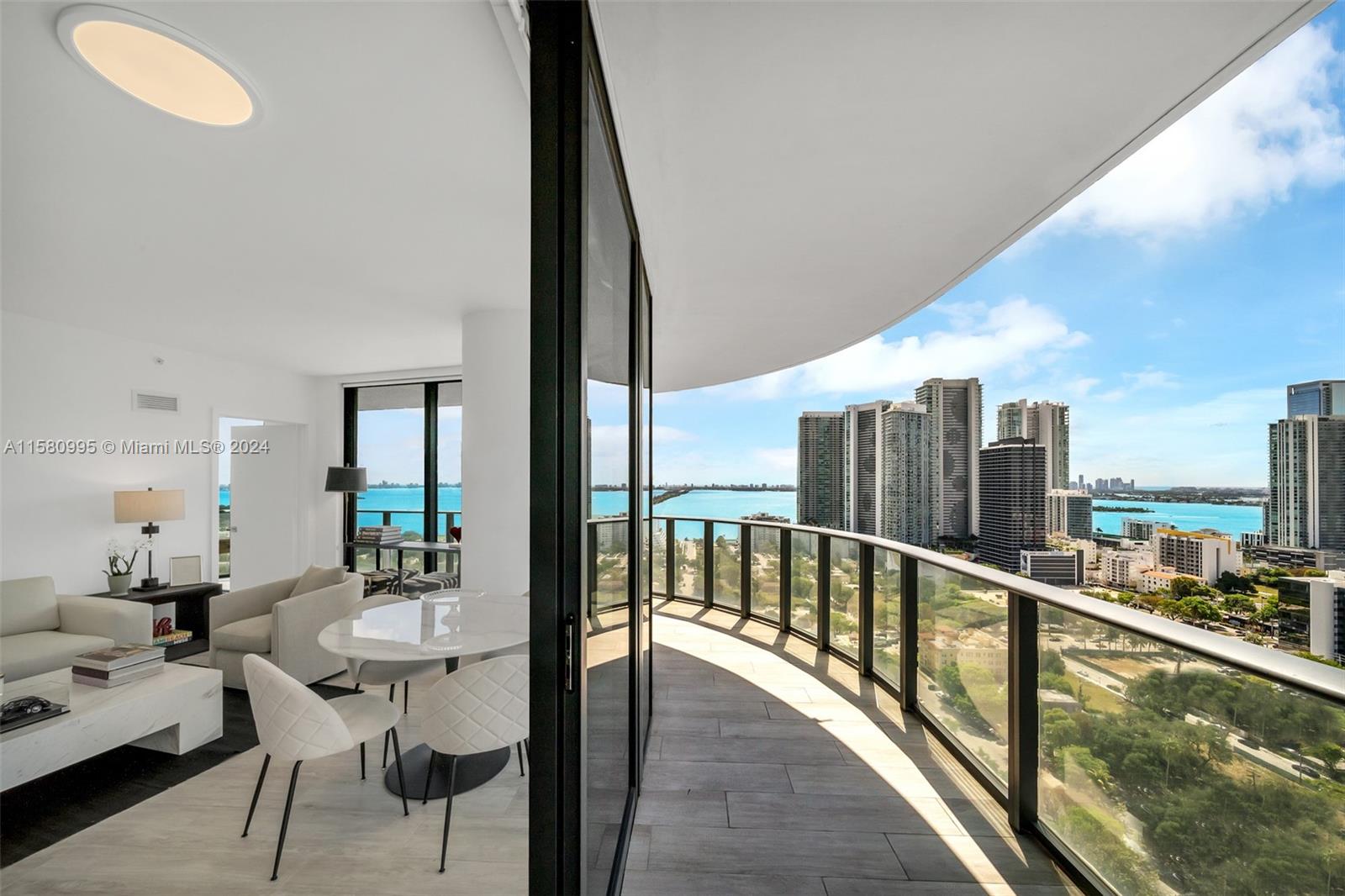 a view of a balcony dining table and chairs