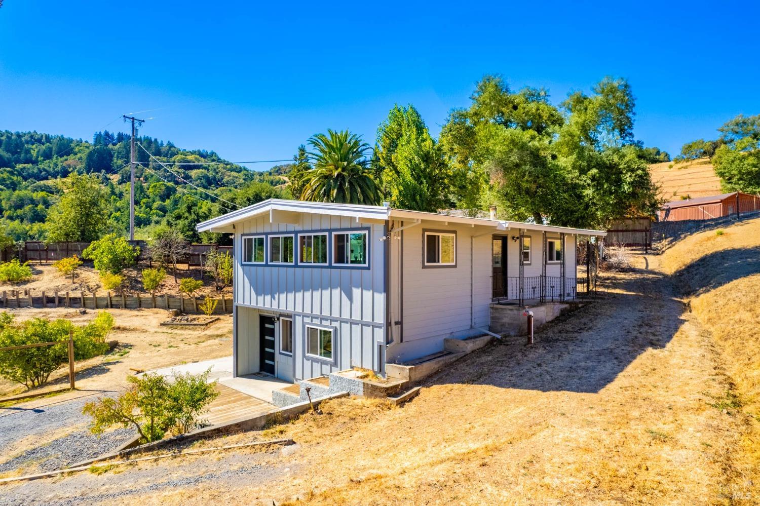 a view of a house with a yard from a patio