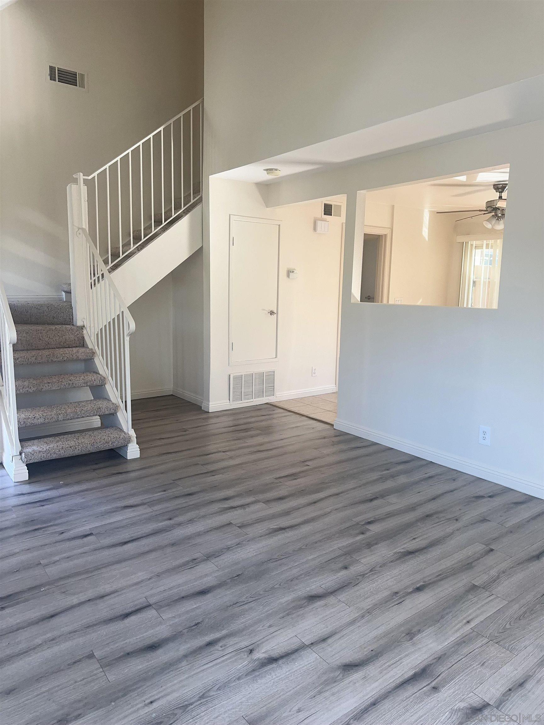 a view of an entryway with wooden floor