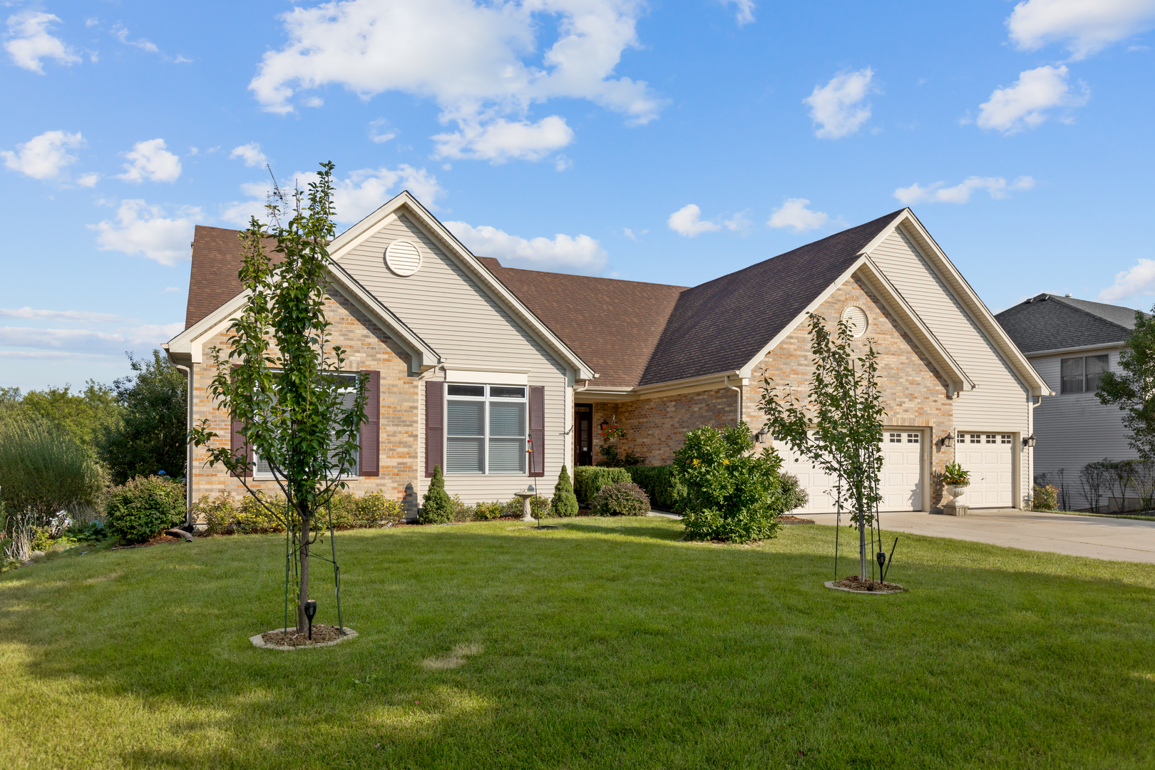 a house view with a garden and trees