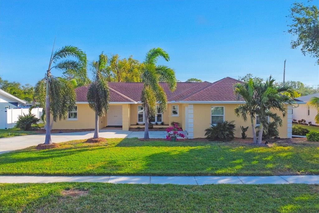 a front view of house with yard and green space