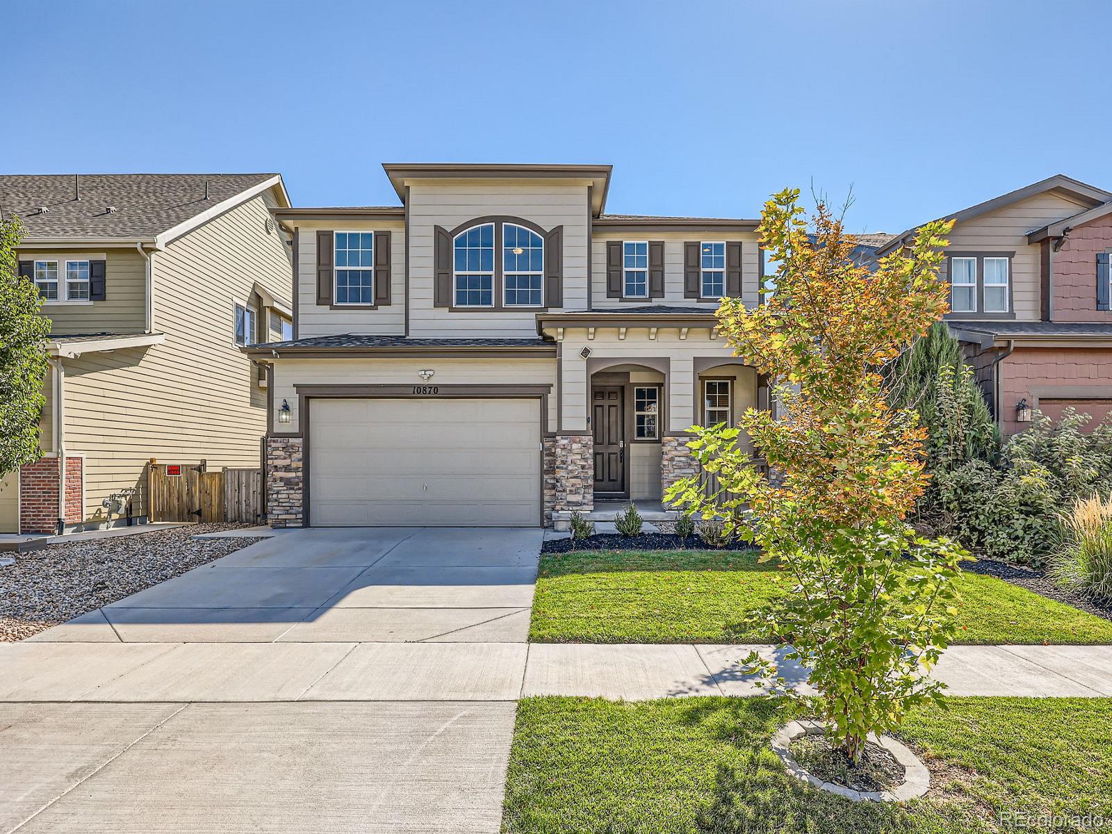 a front view of a house with a yard and garage