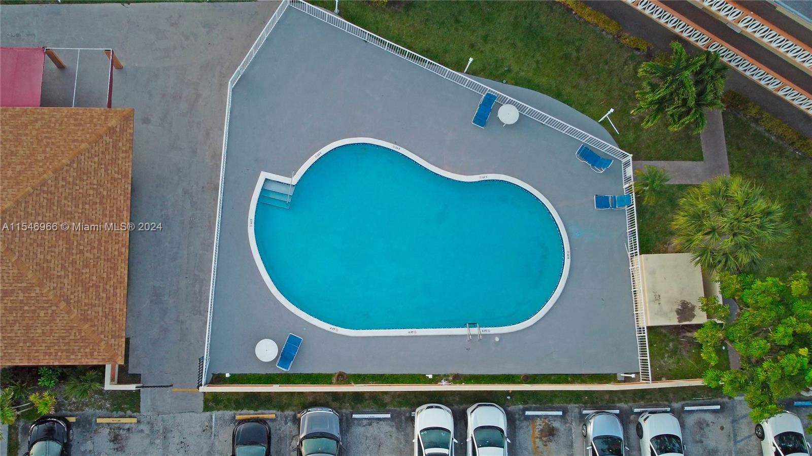 an aerial view of a house with swimming pool and glass windows