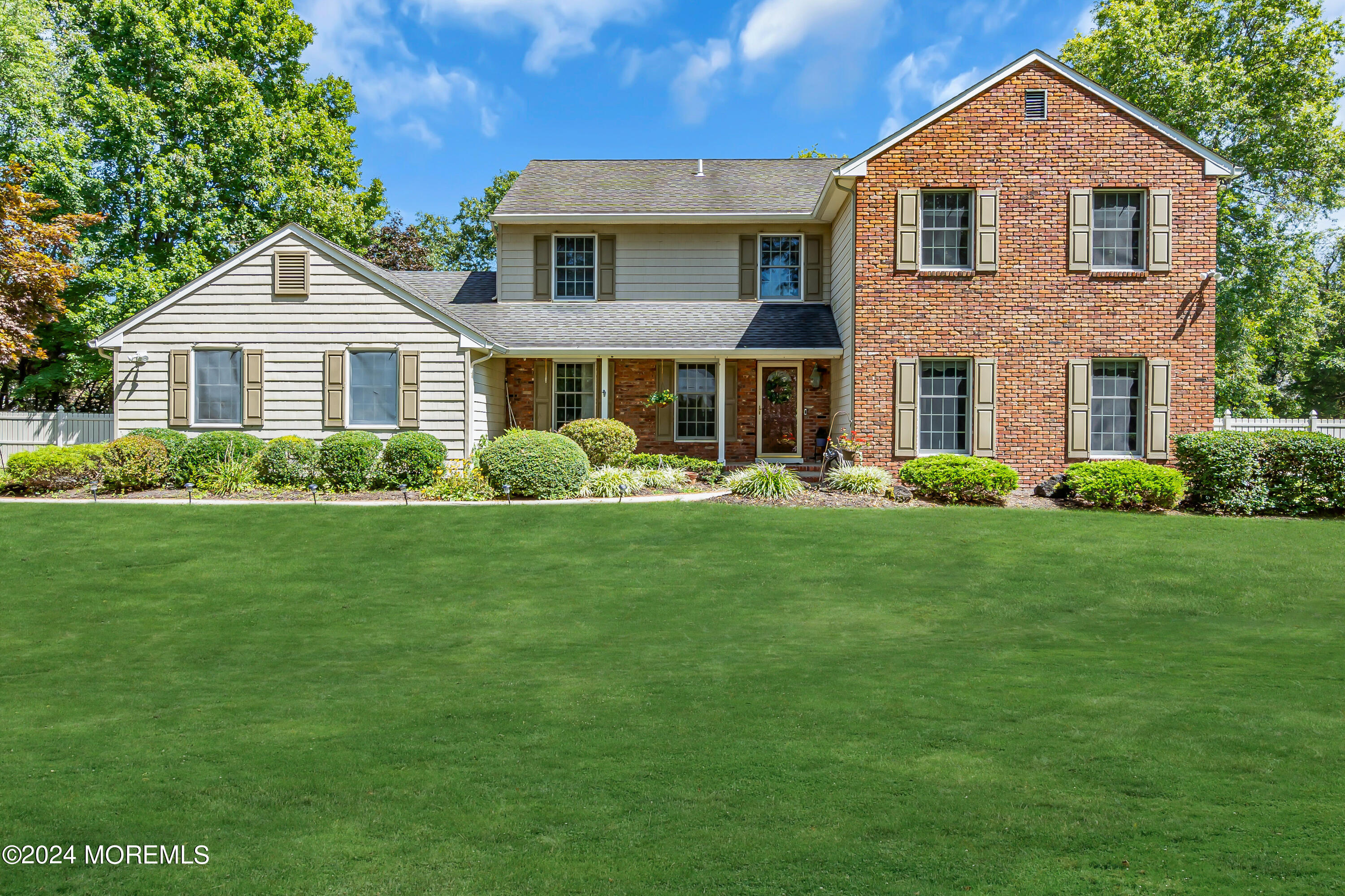 a front view of house with yard and green space