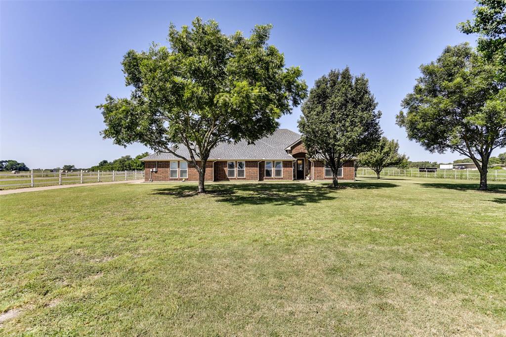 a view of a house with pool and a yard