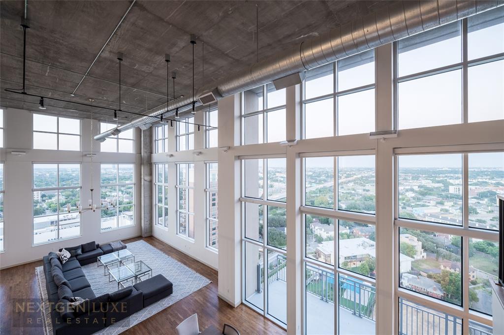 a living room with furniture and a floor to ceiling window