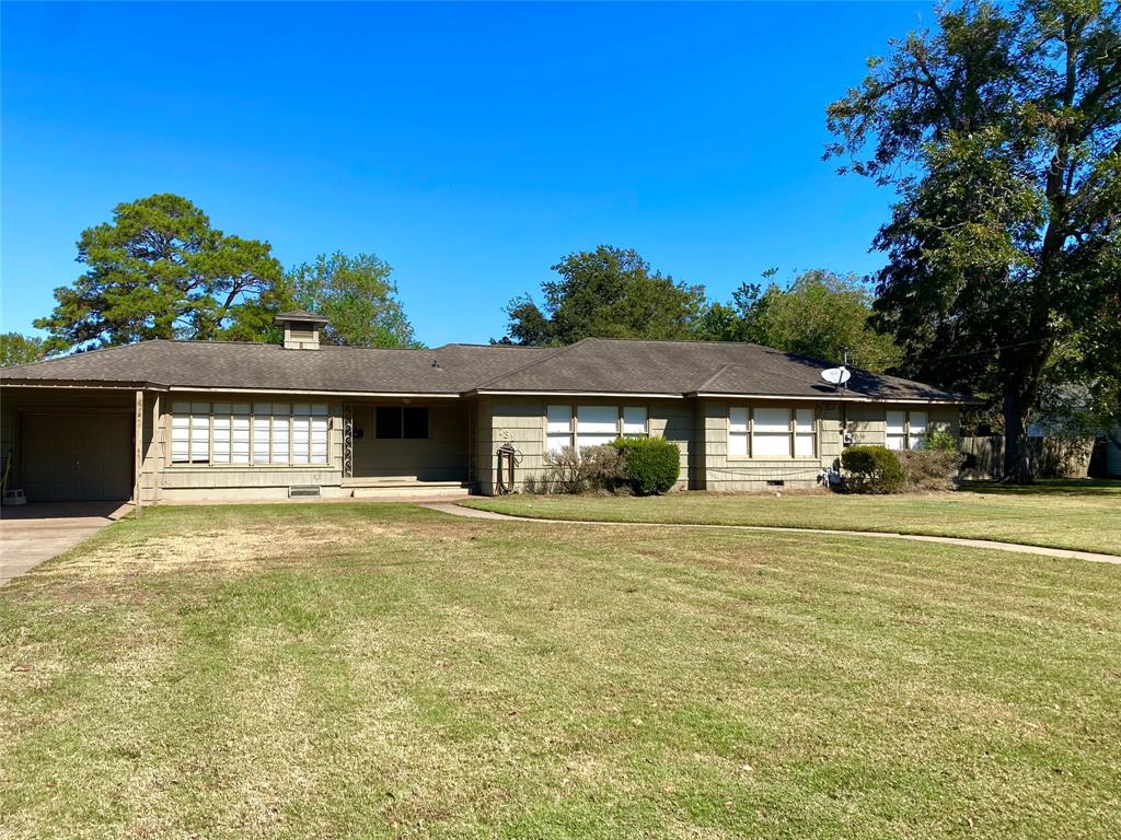 a front view of a house with a big yard