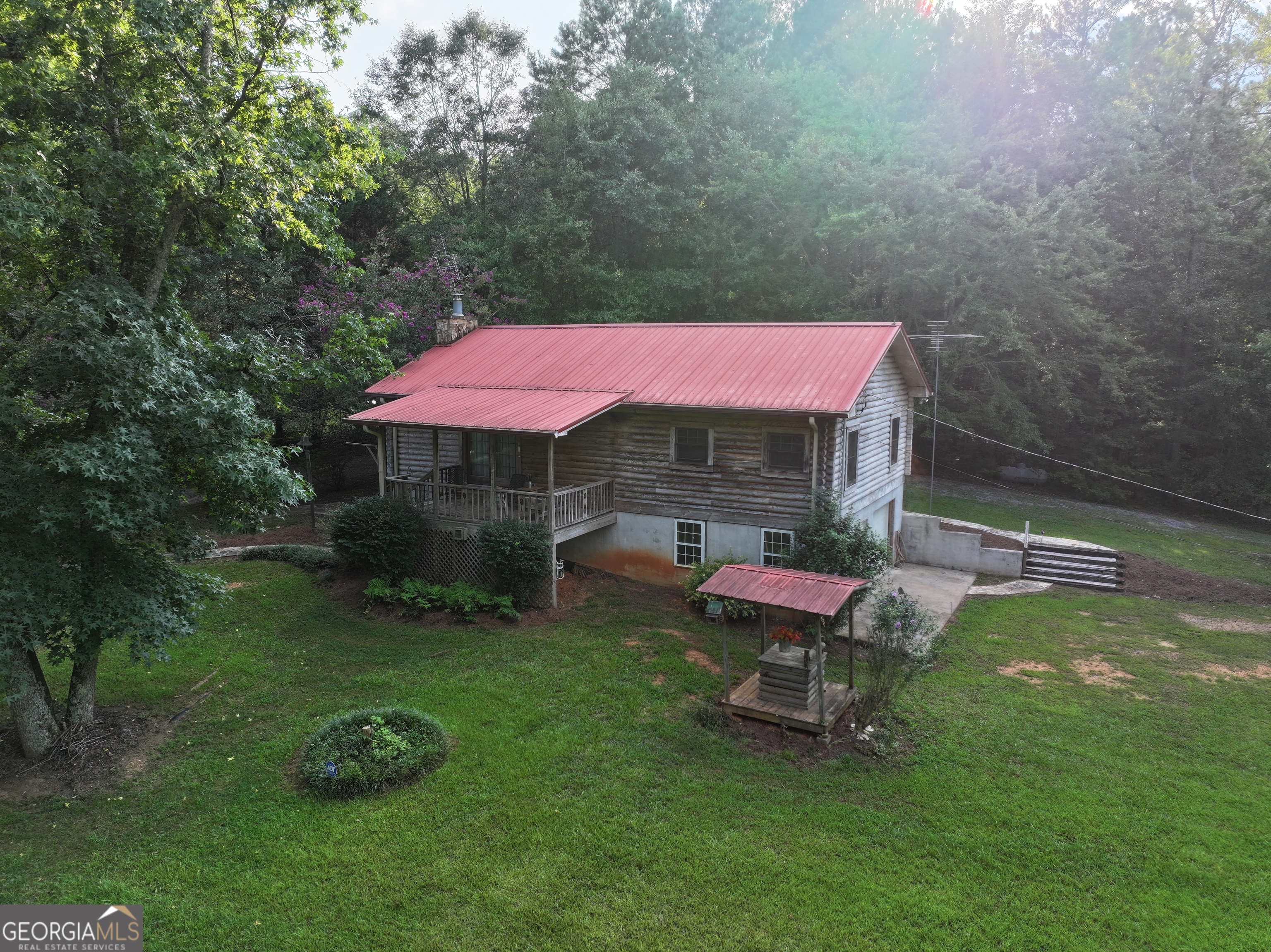 a view of a backyard with table and chairs under an umbrella