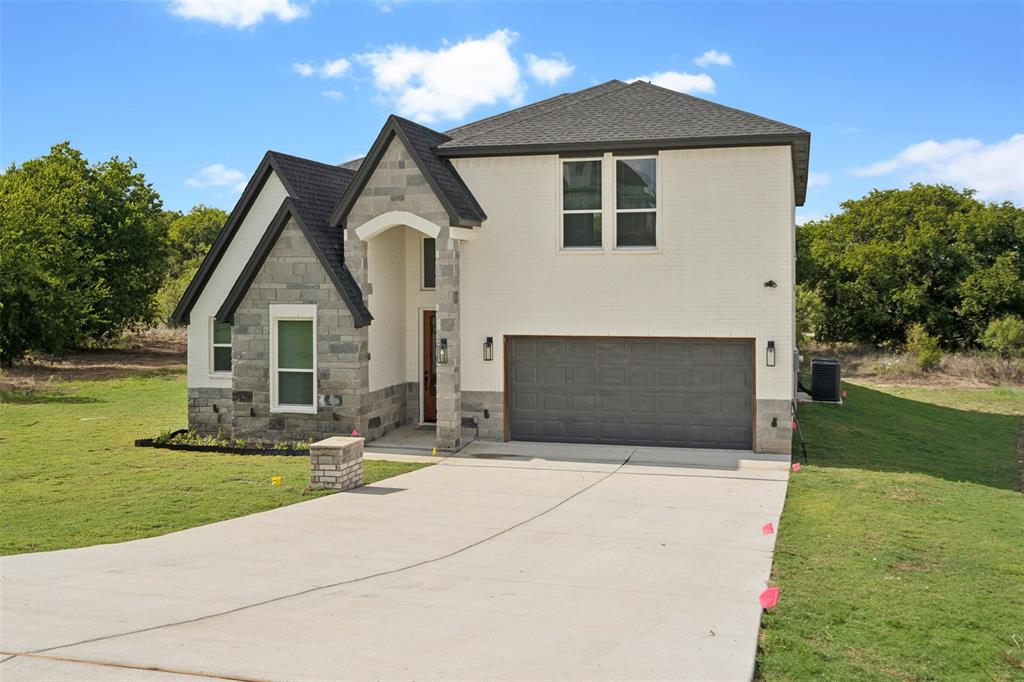 a front view of house with yard and green space