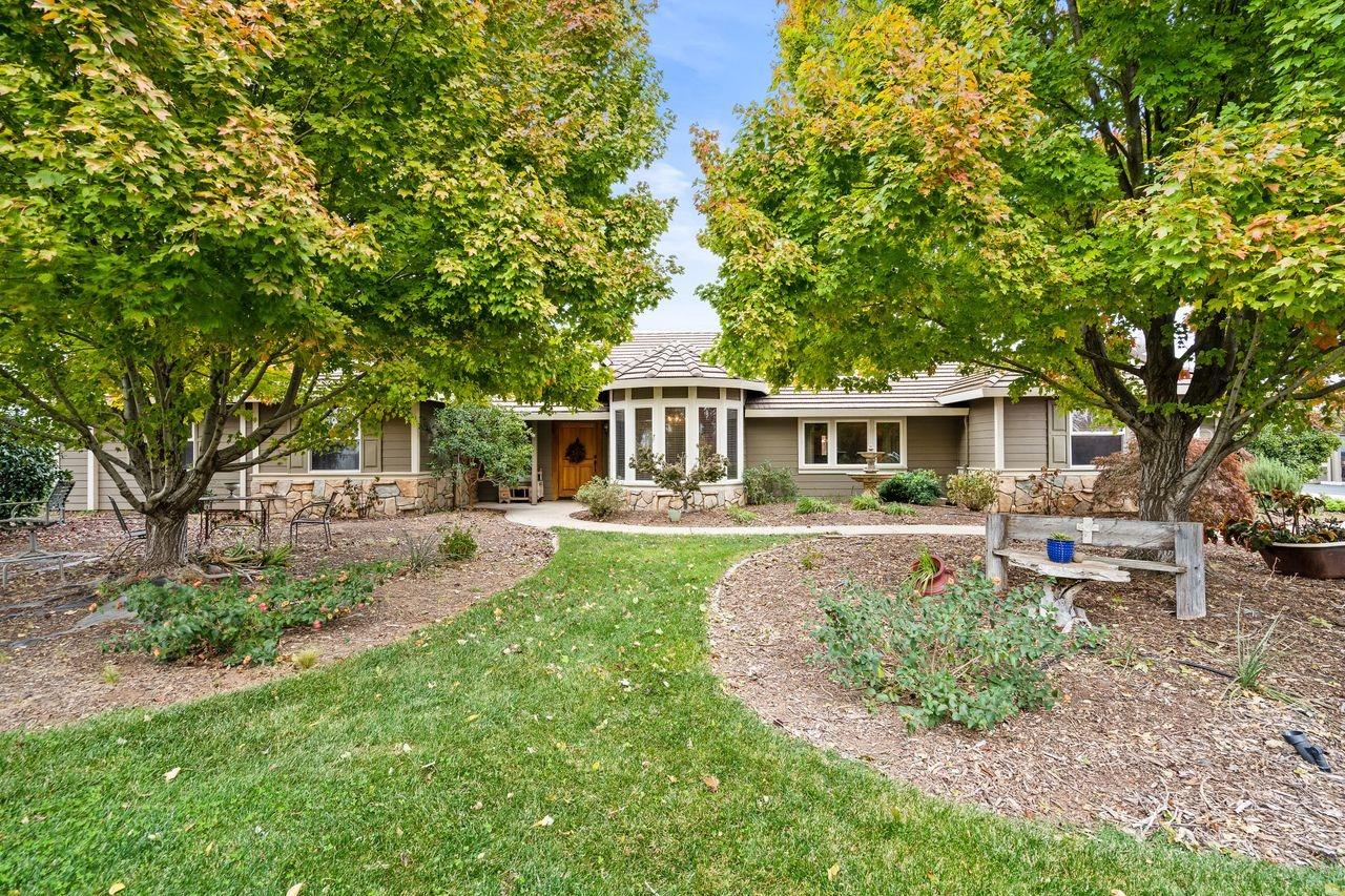 a front view of a house with a garden