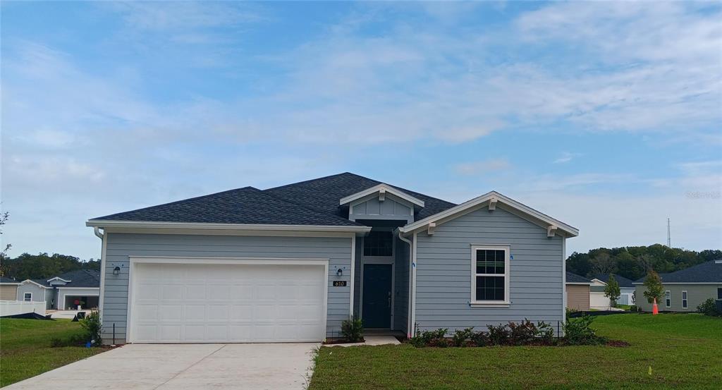 a front view of a house with a yard