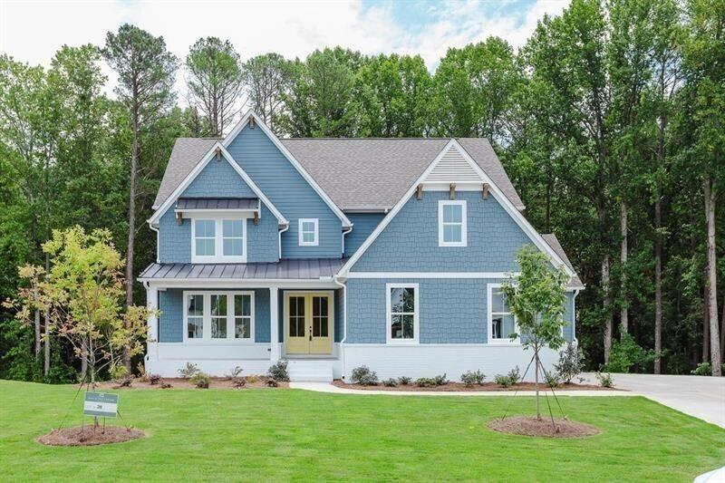 a front view of house with yard and green space