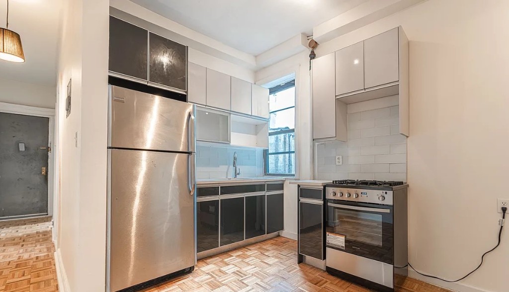 a kitchen with stainless steel appliances granite countertop a refrigerator and a stove