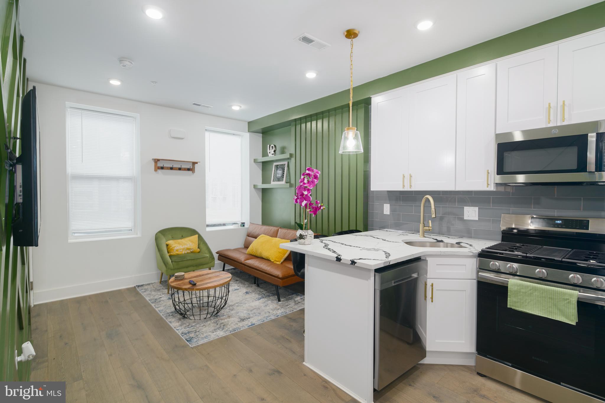 a kitchen that has a lot of cabinets in it and appliances