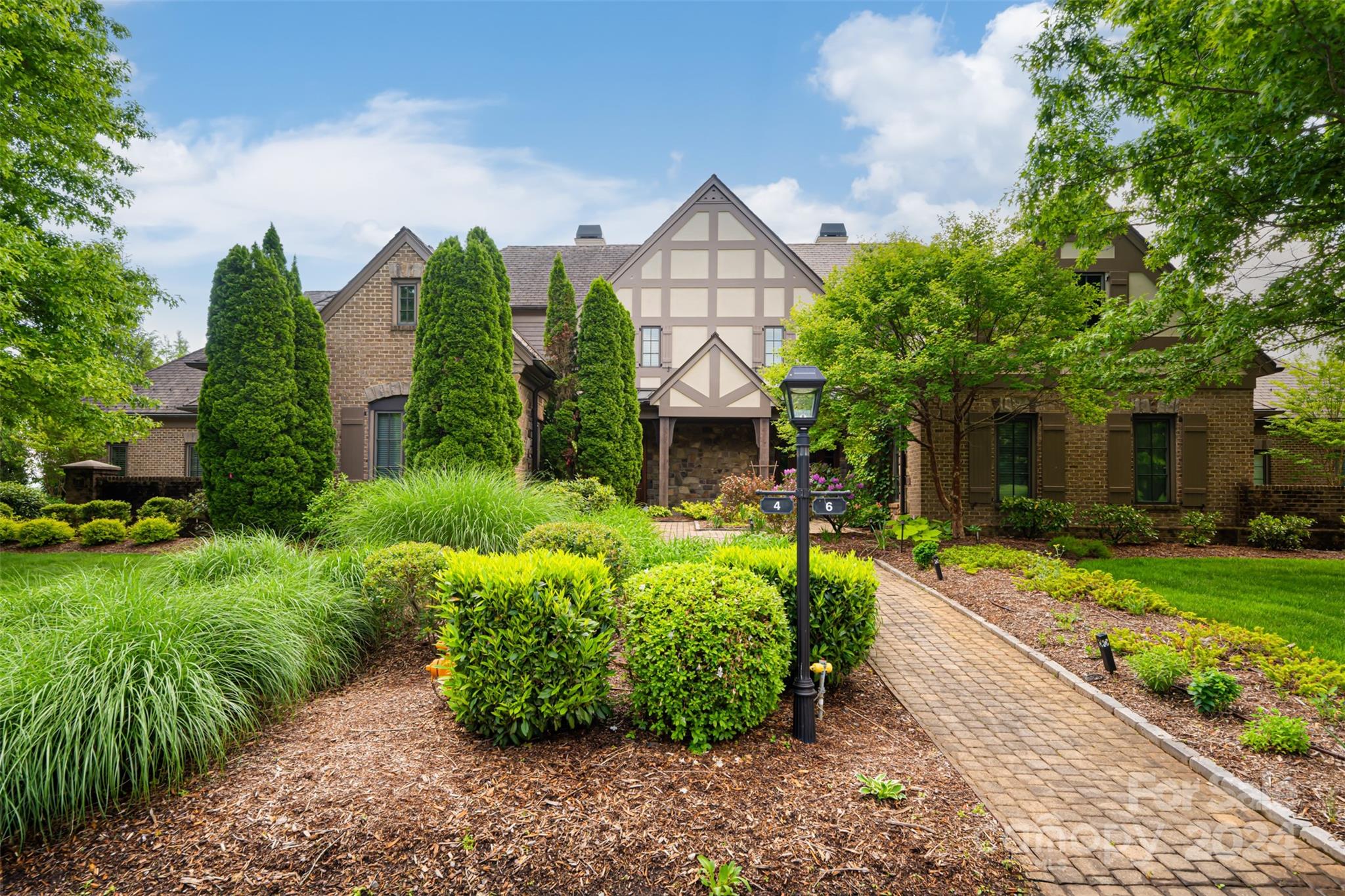 a front view of a house with garden