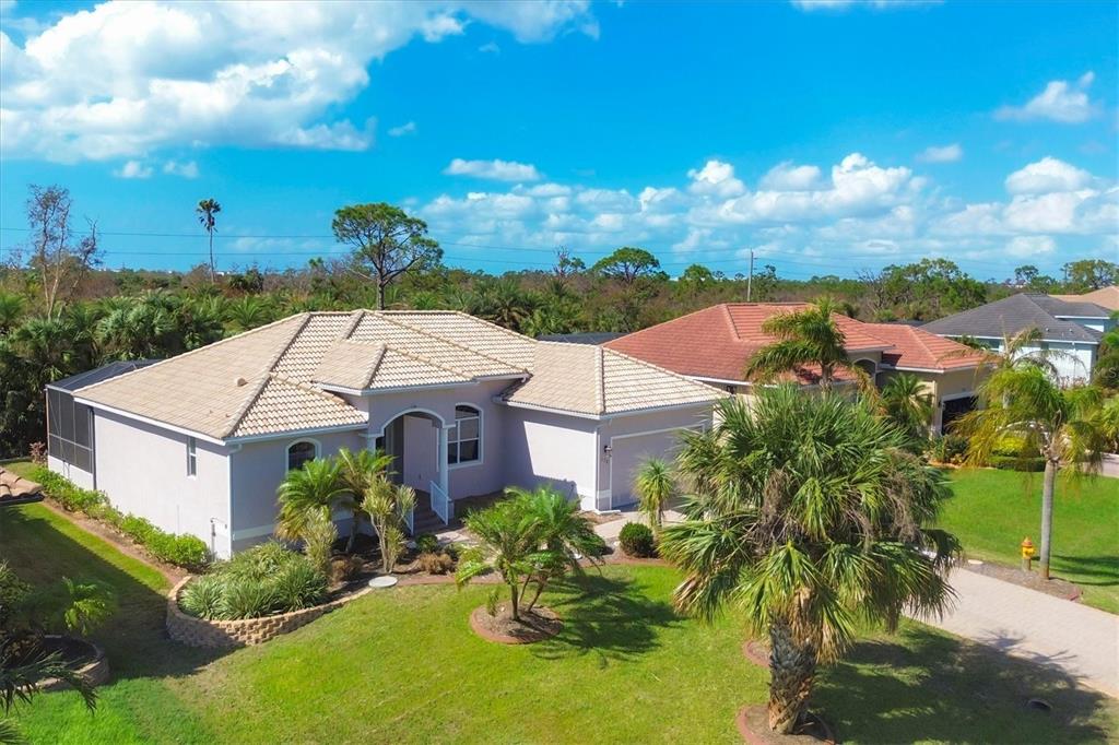 aerial view of a house with yard and green space