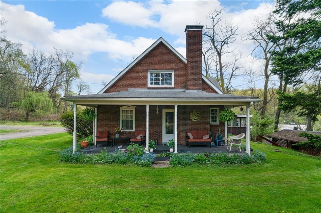 a view of a house with a yard and a garden