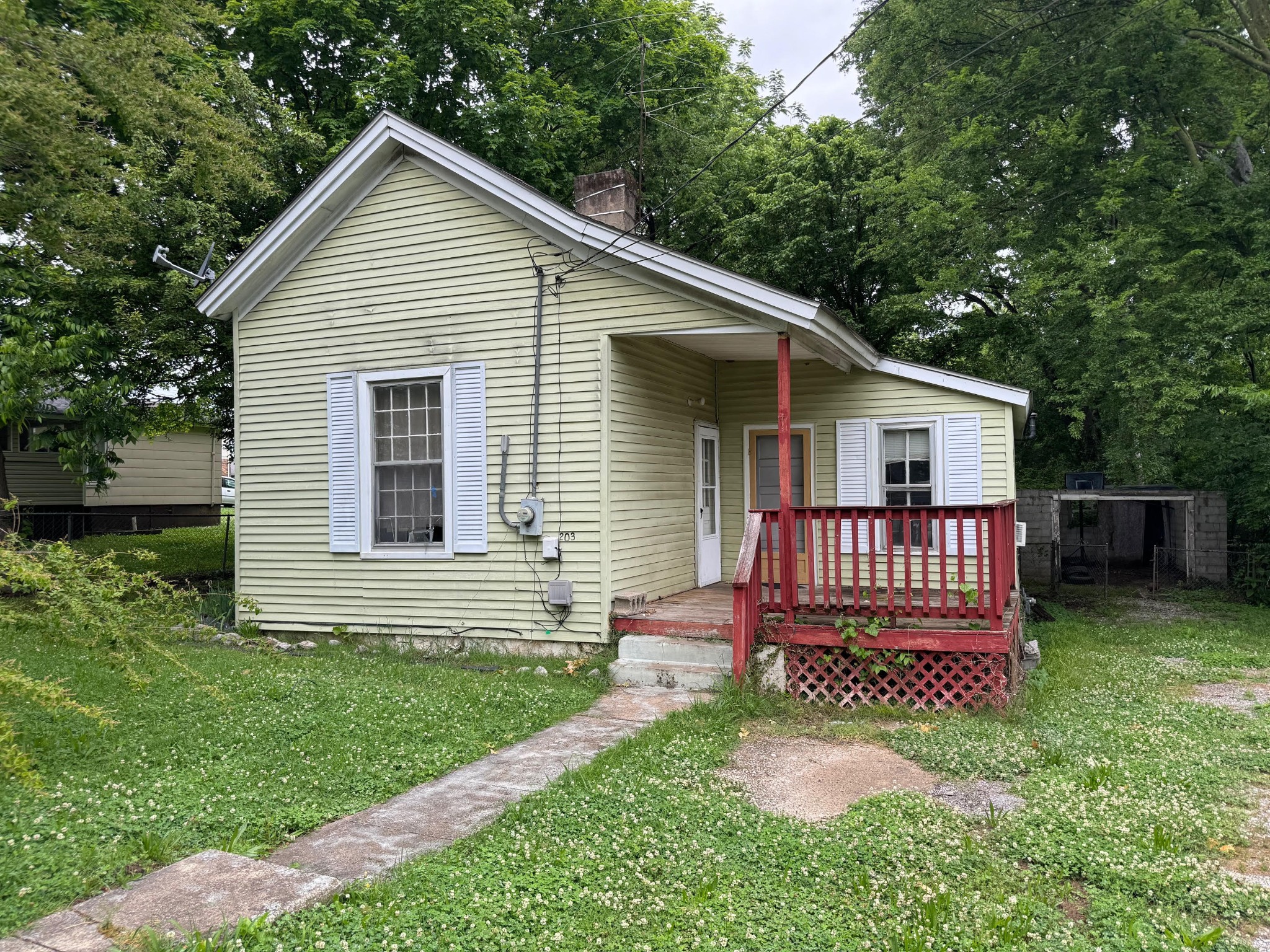 a front view of a house with a yard and fence