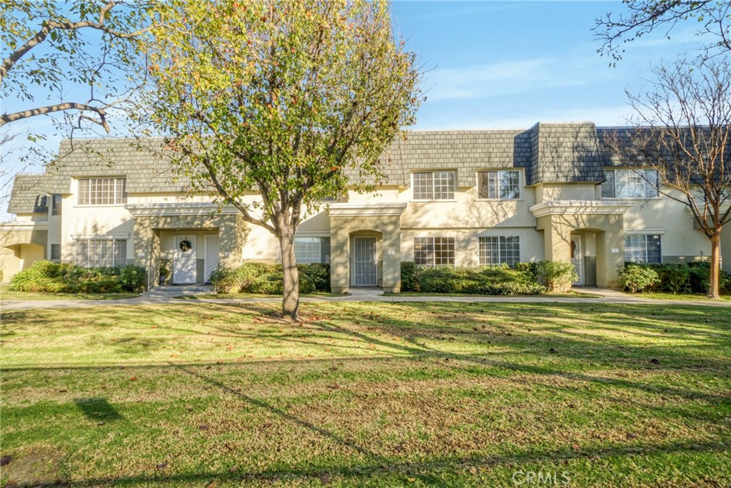 a front view of residential houses with yard