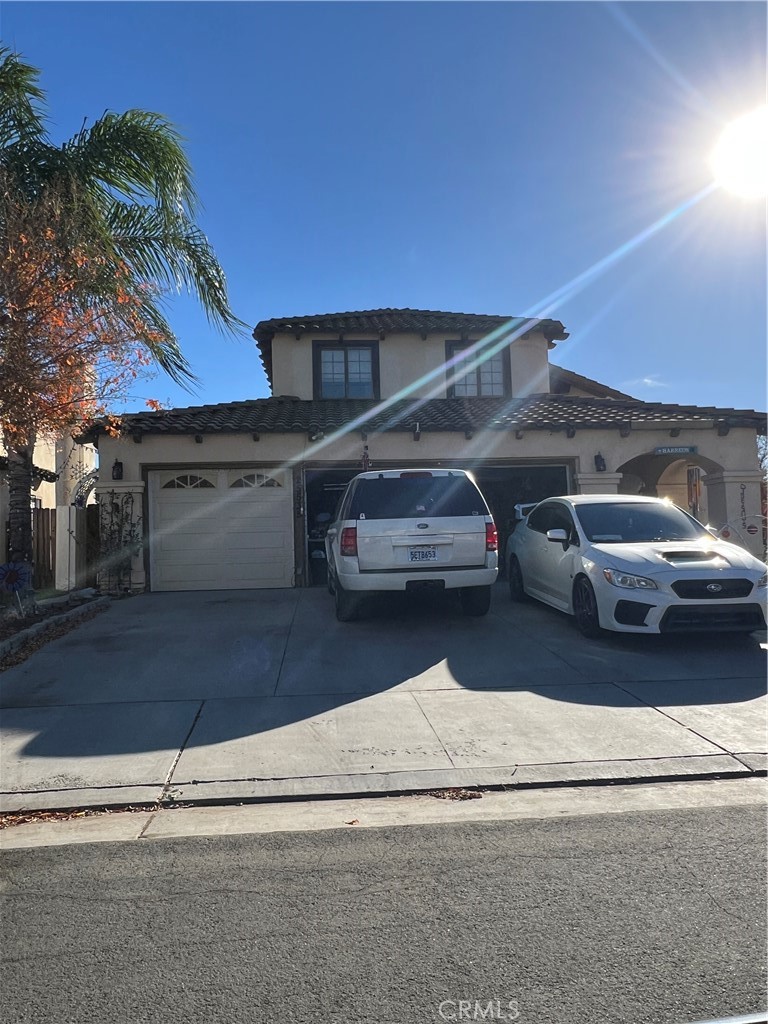 a view of garage with a car parked on the road