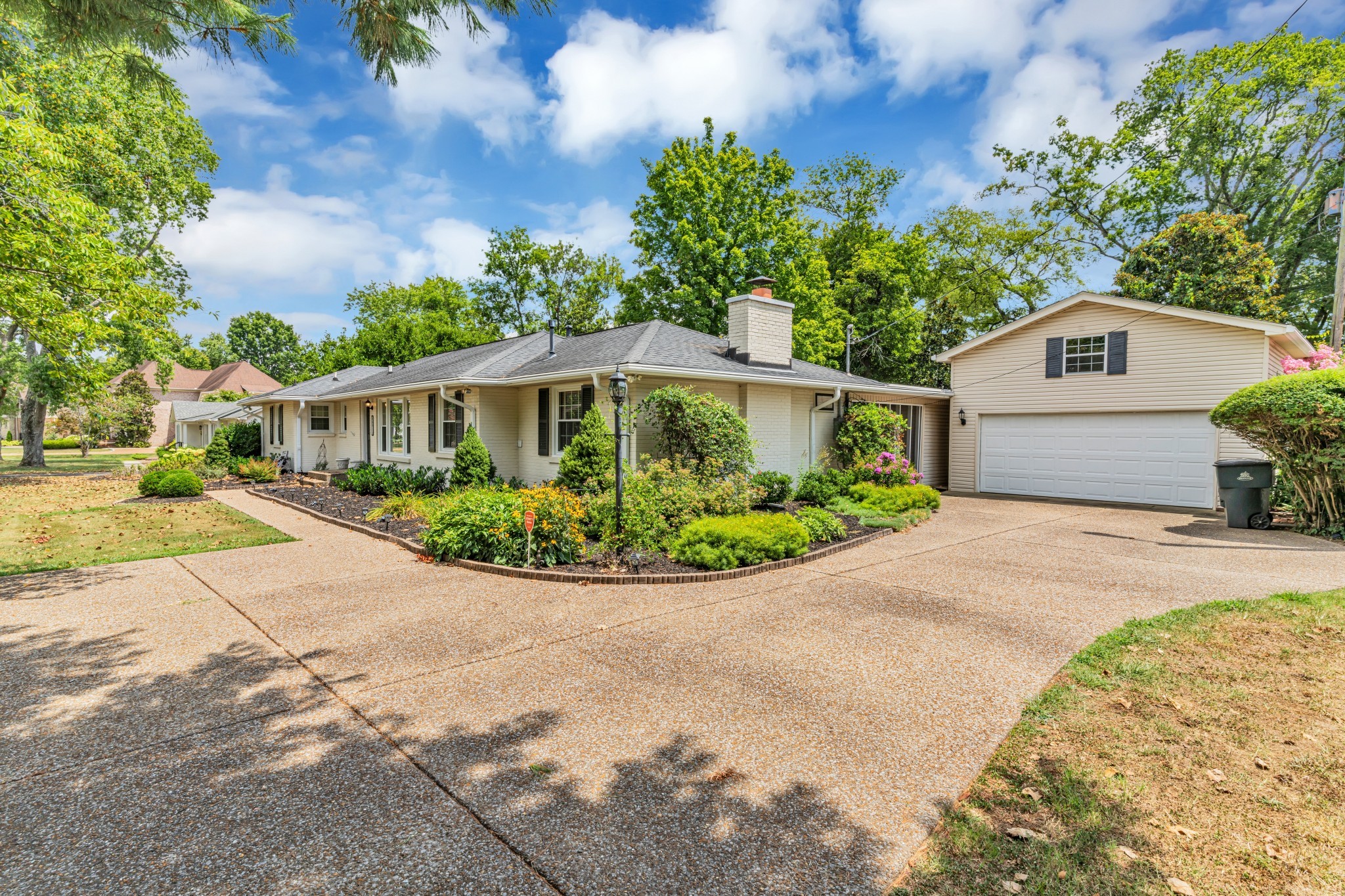 a front view of a house with a garden