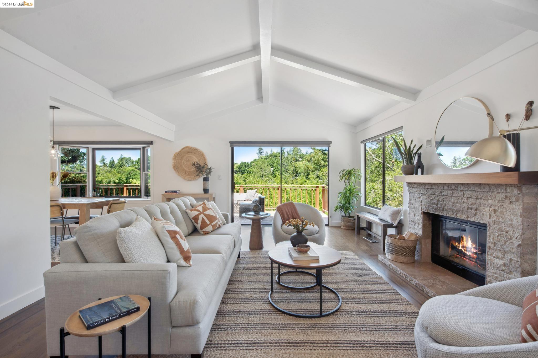 a living room with furniture fireplace and a large window