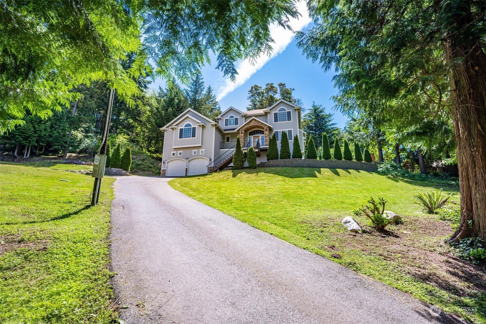 a front view of a house with yard and green space