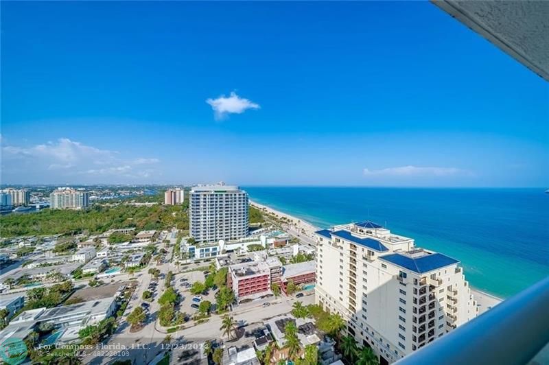 a view of a city with an ocean view