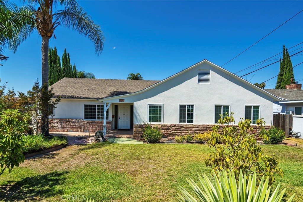 a front view of a house with a yard and porch