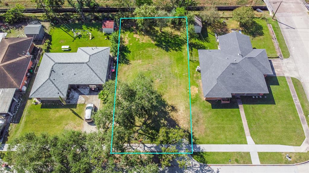 an aerial view of a house with a garden and swimming pool