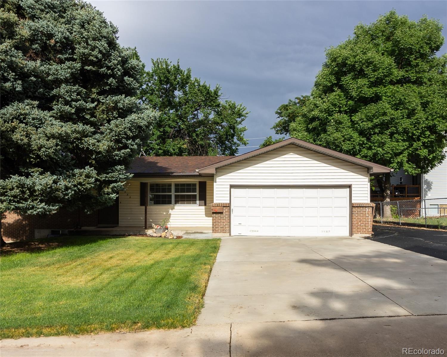 a view of a house with a yard and garage