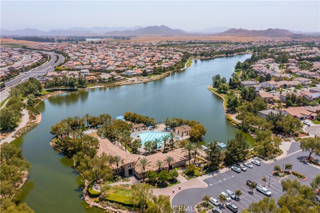 an aerial view of lake and residential houses with outdoor space