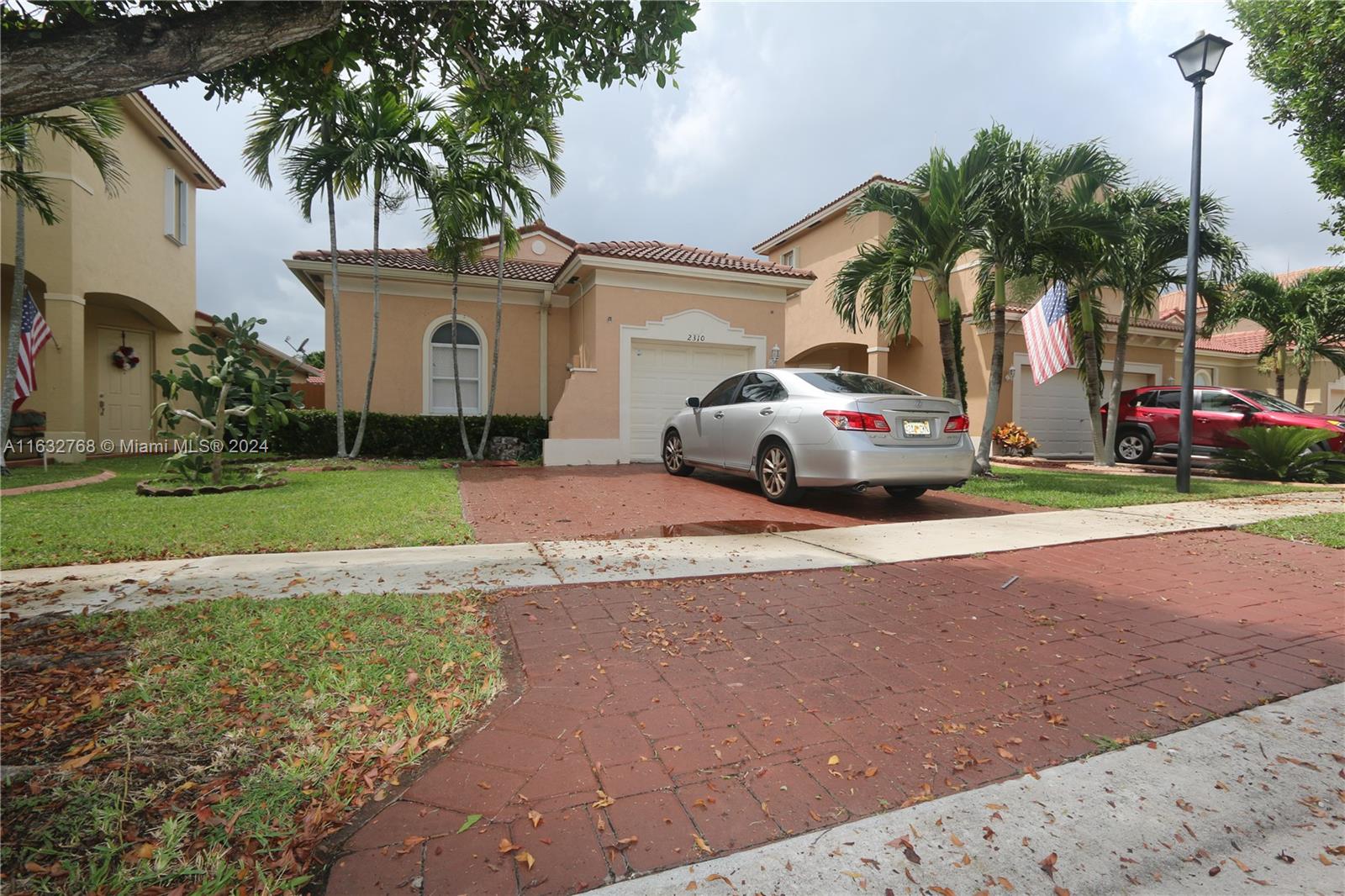 a yellow house with palm tree in front of it