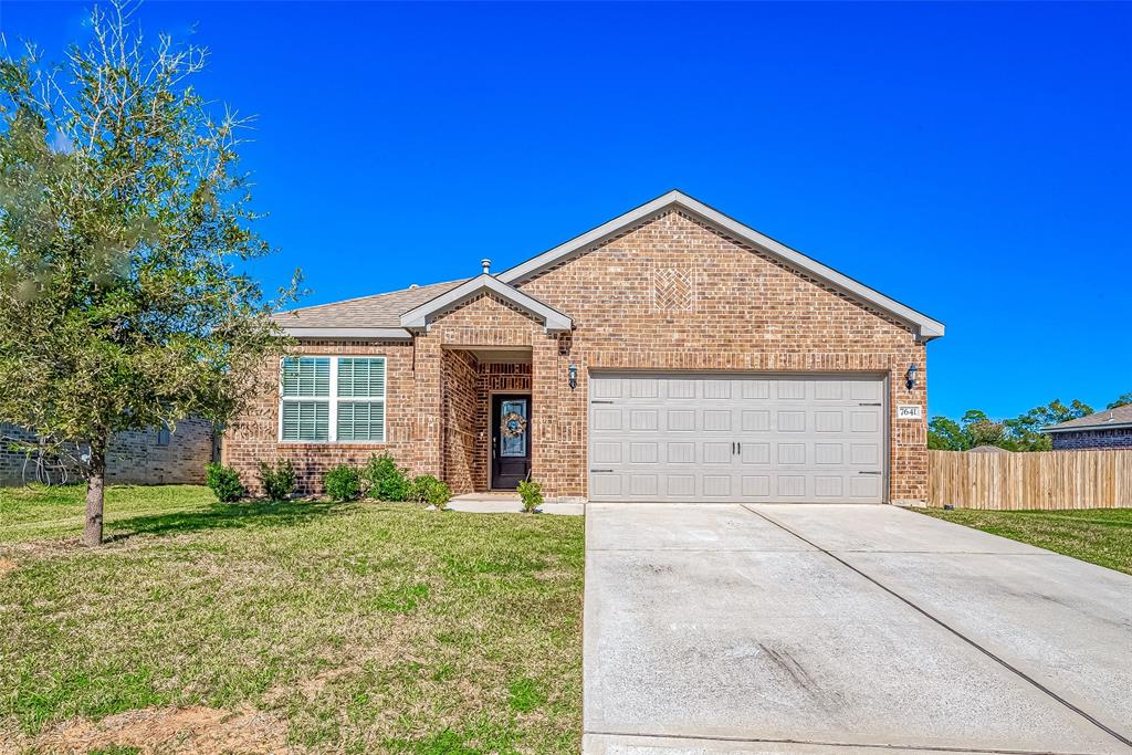 This is a single-story brick home featuring a two-car garage and nice curb appeal.