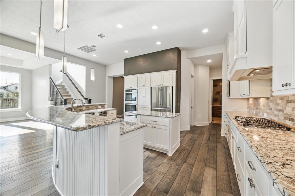 a large white kitchen with a large window