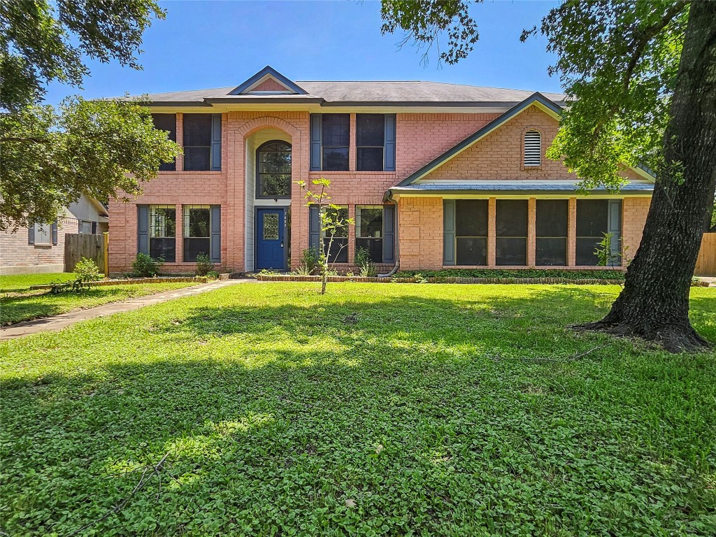 a front view of a house with a garden