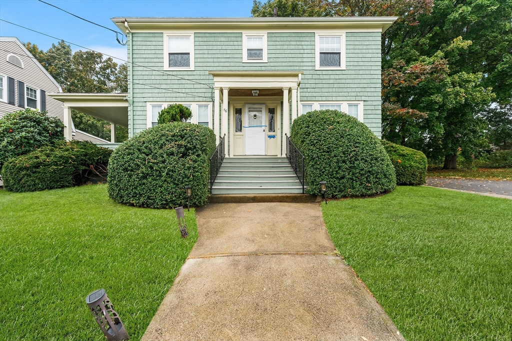 a front view of a house with garden