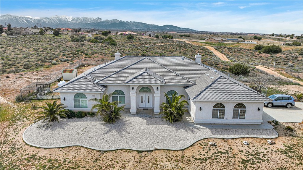 an aerial view of a house with a yard