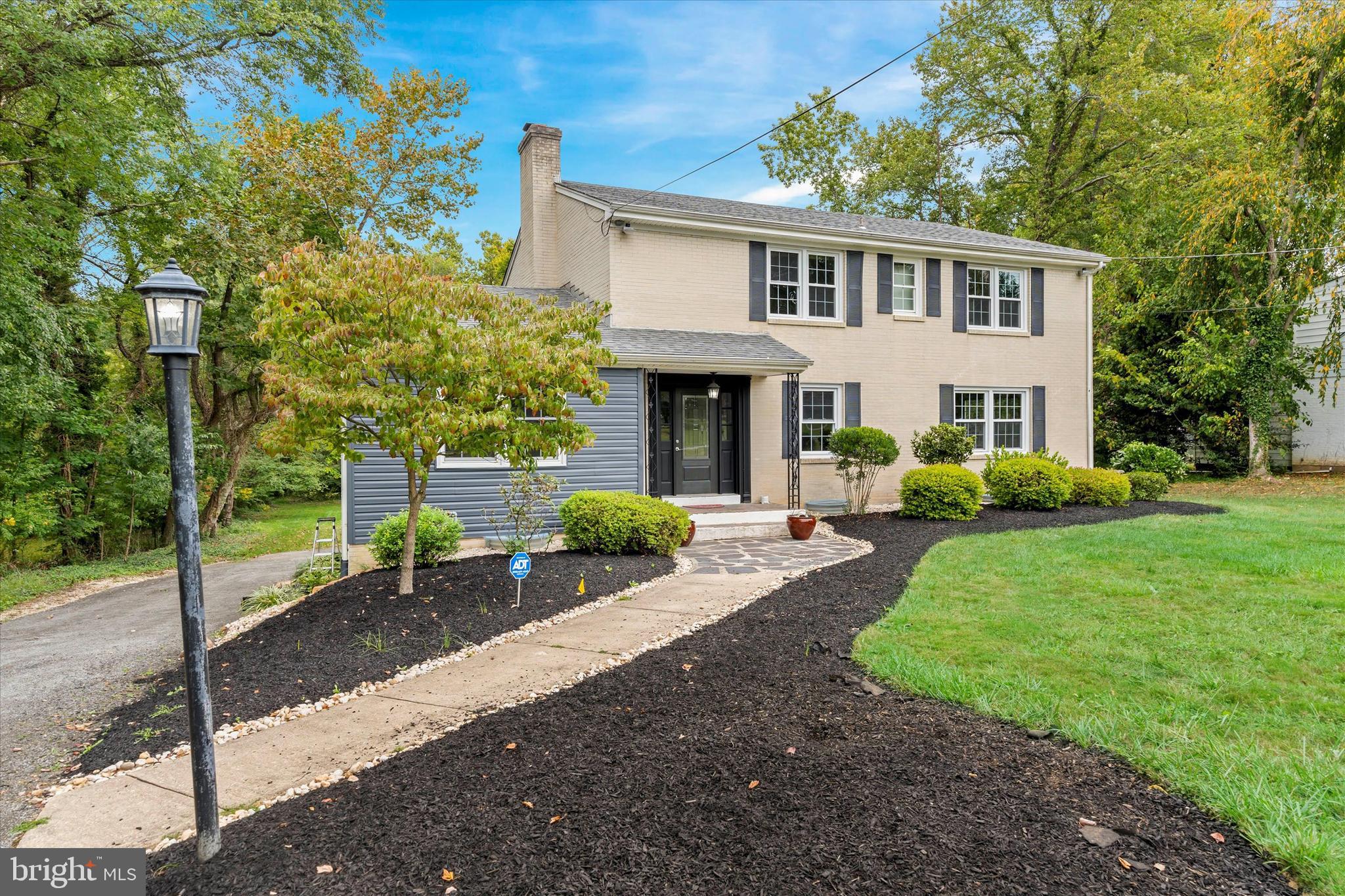 a front view of a house with a yard and porch