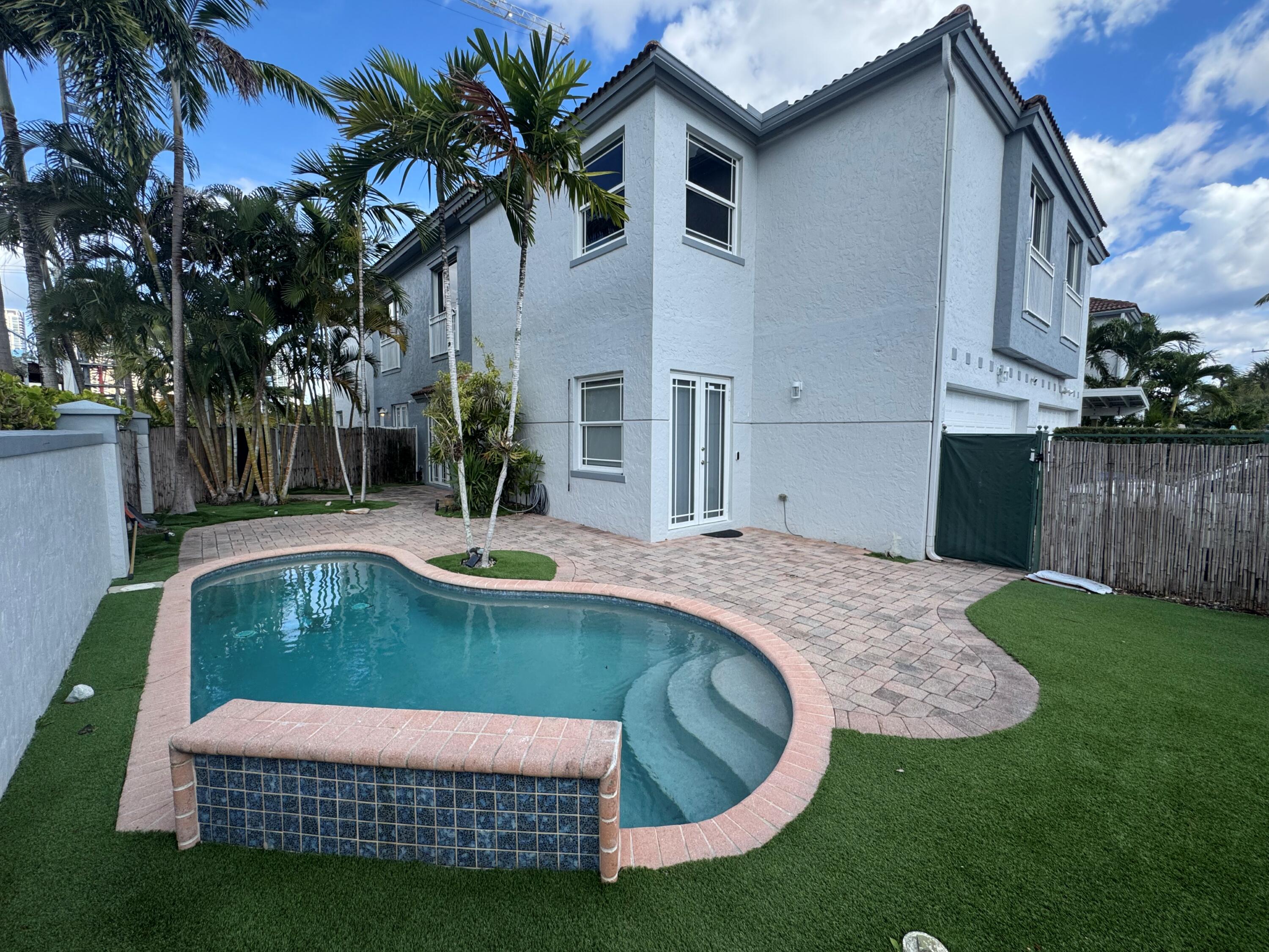 a view of a house with swimming pool and a yard