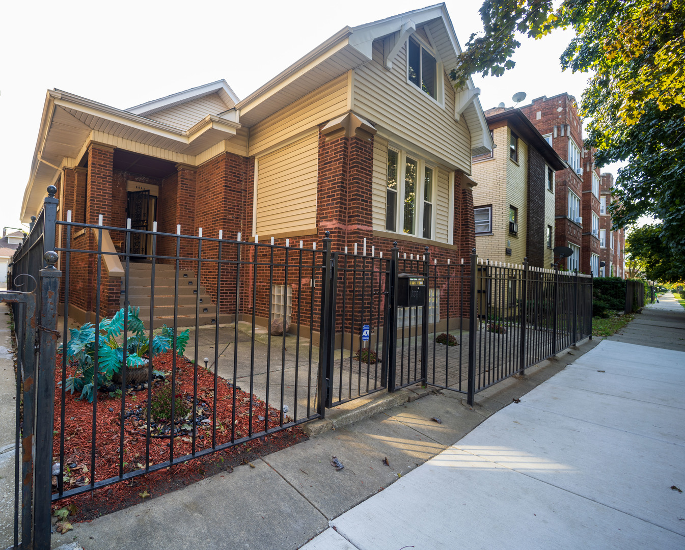 a view of a house with a small yard and plants