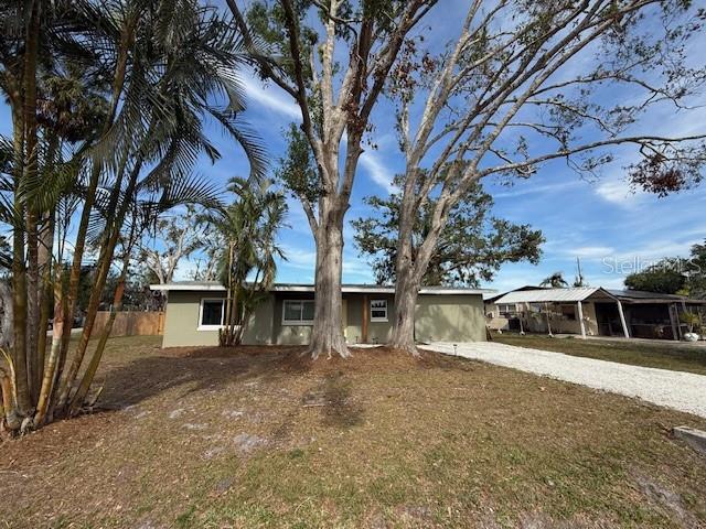 a view of a house with a large tree