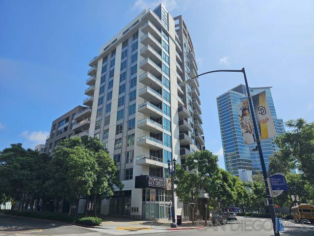 a view of a tall building next to a road