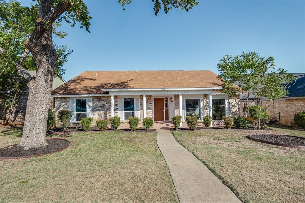 a front view of a house with garden and porch