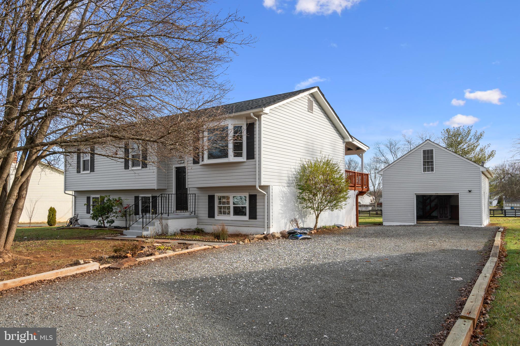 a view of house with yard in front of it