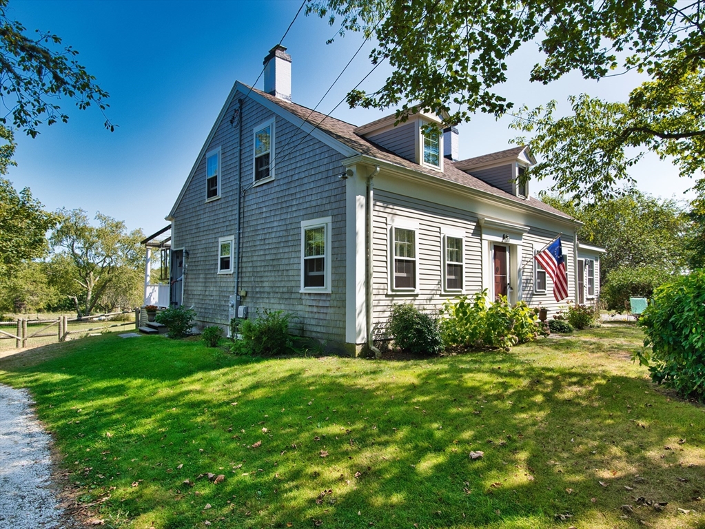 a front view of house with yard and green space