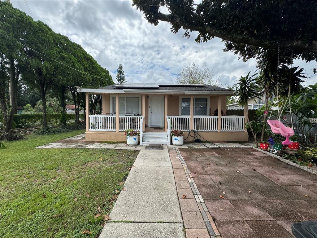 a front view of house with yard and green space