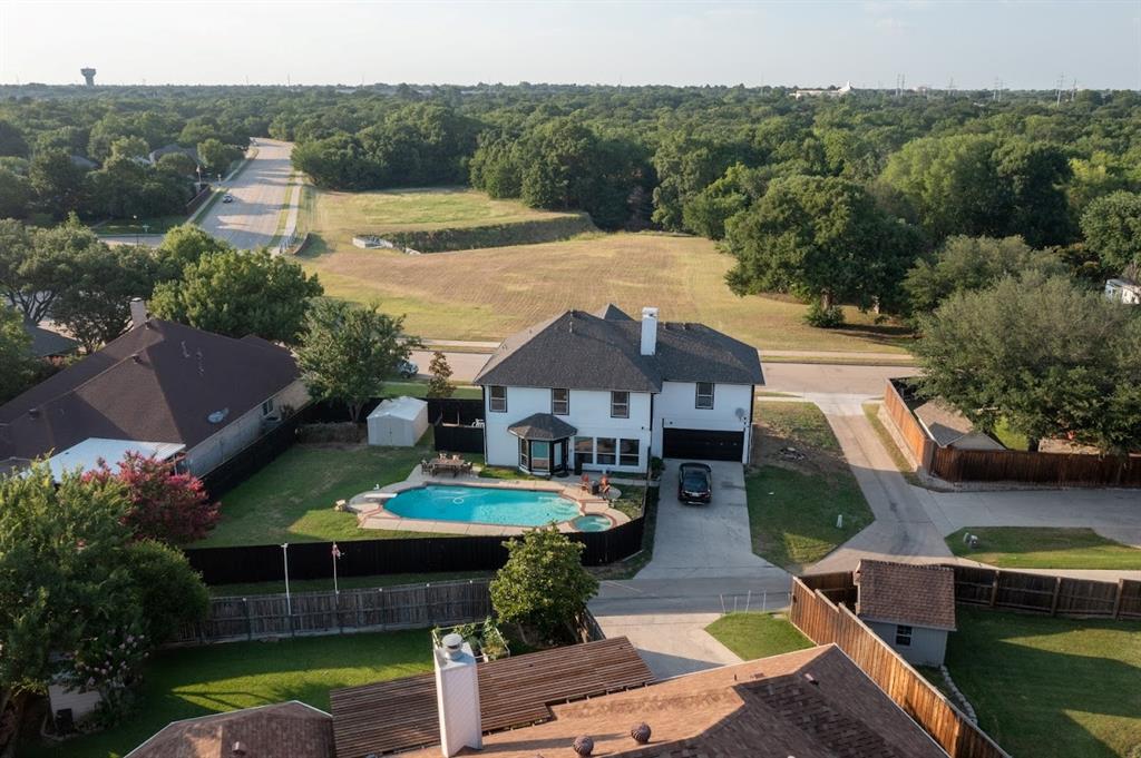 an aerial view of a house with garden space and street view